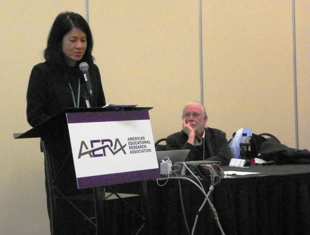 Woman introducing speaker at an AERA conference session
