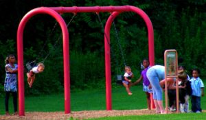 Kids playing on a swing at a playground
