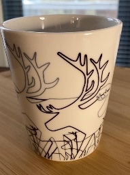 Conical cup with reindeers drawn in black and white
